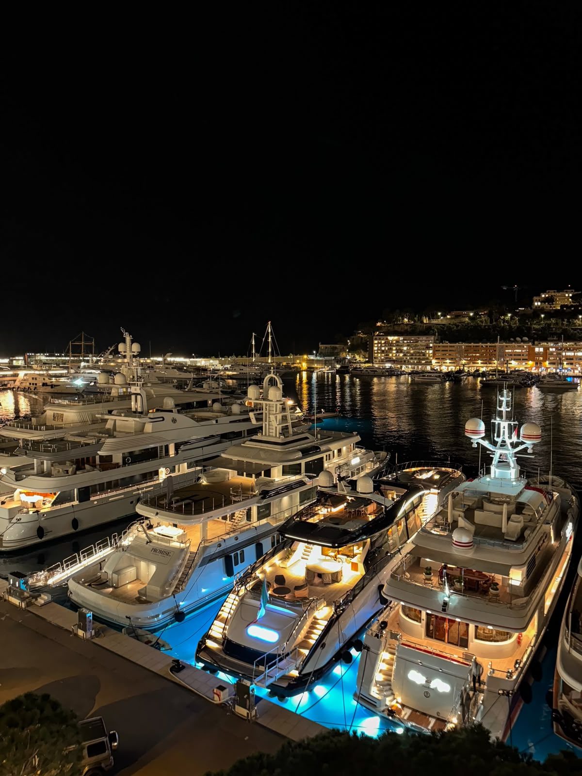Superyachts moored at Port Hercule, Monaco, lit up at night ahead of the Monaco Yacht Show